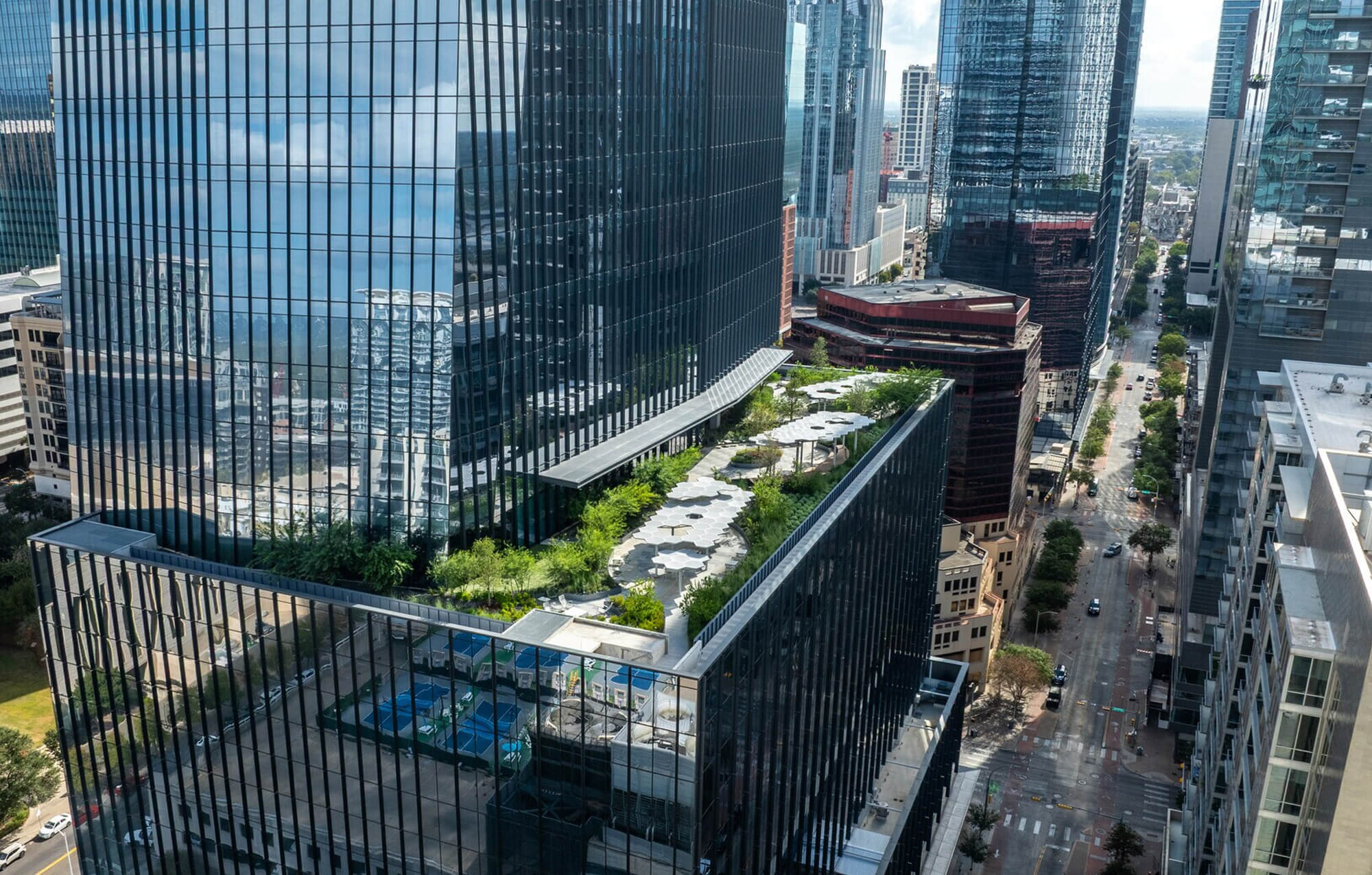 Digital rendering of metallic office tower with terrace in downtown Austin