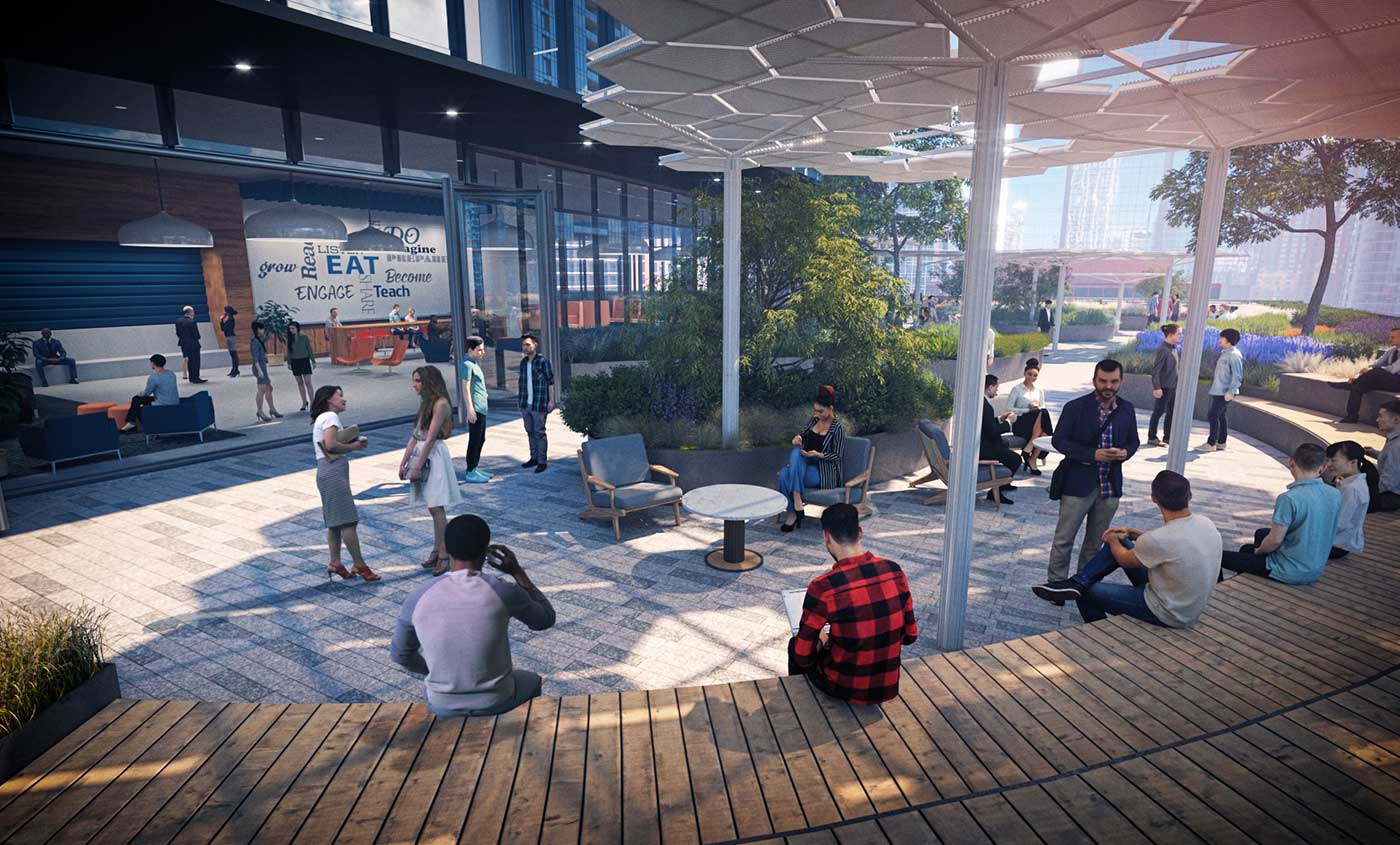 A group utilizes and outdoor lounge area with wooden platform seating