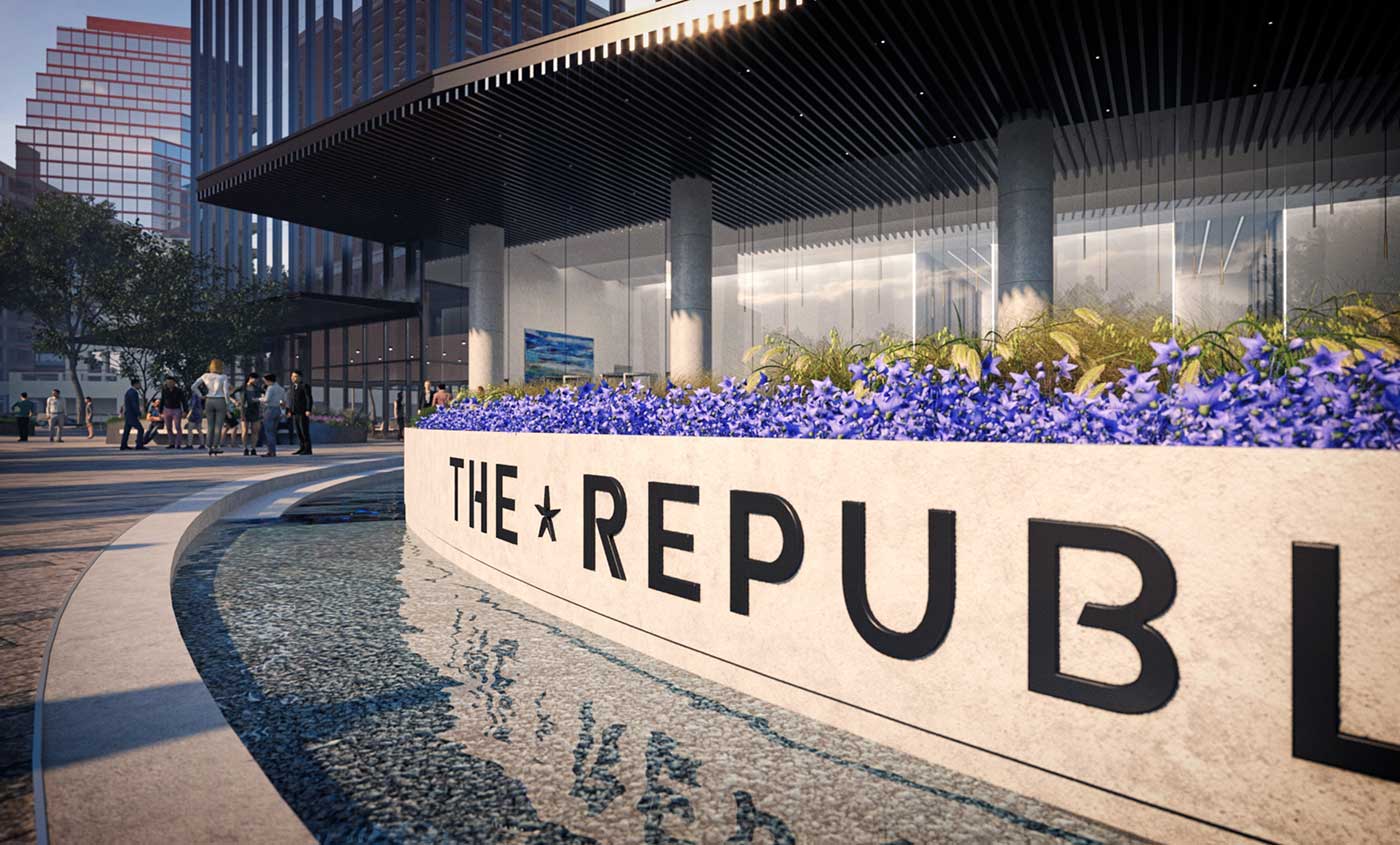 Entrance sign with water and purple flowers for The Republic