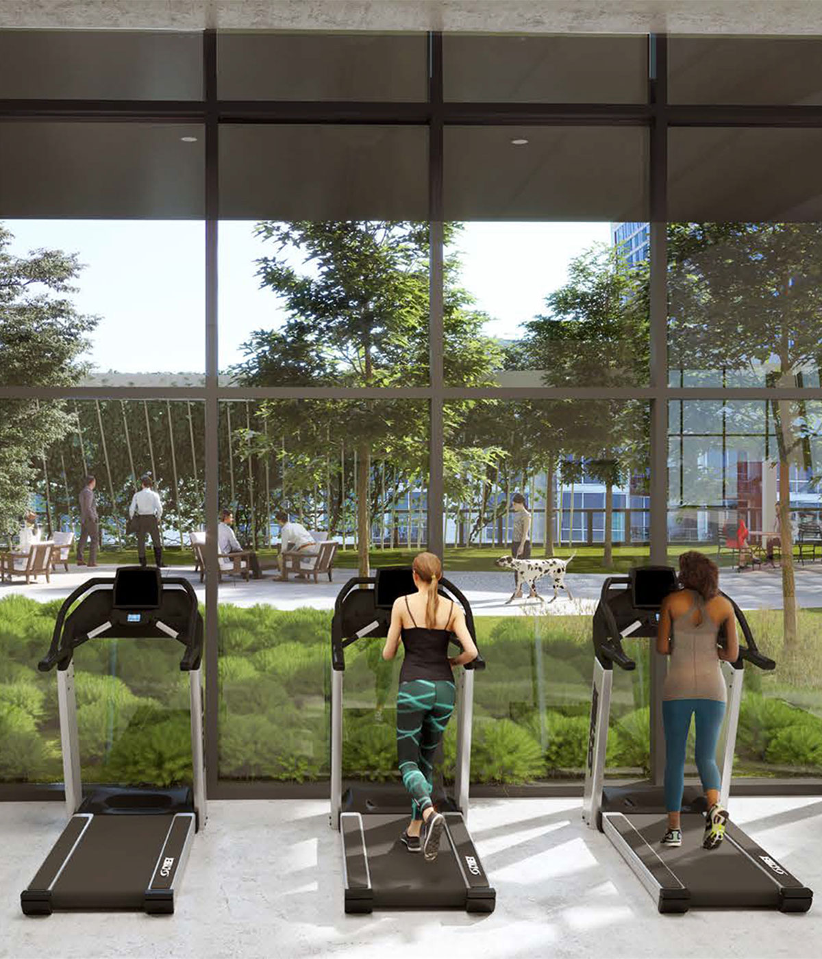 Two women use treadmills in a gym overlooking a courtyard