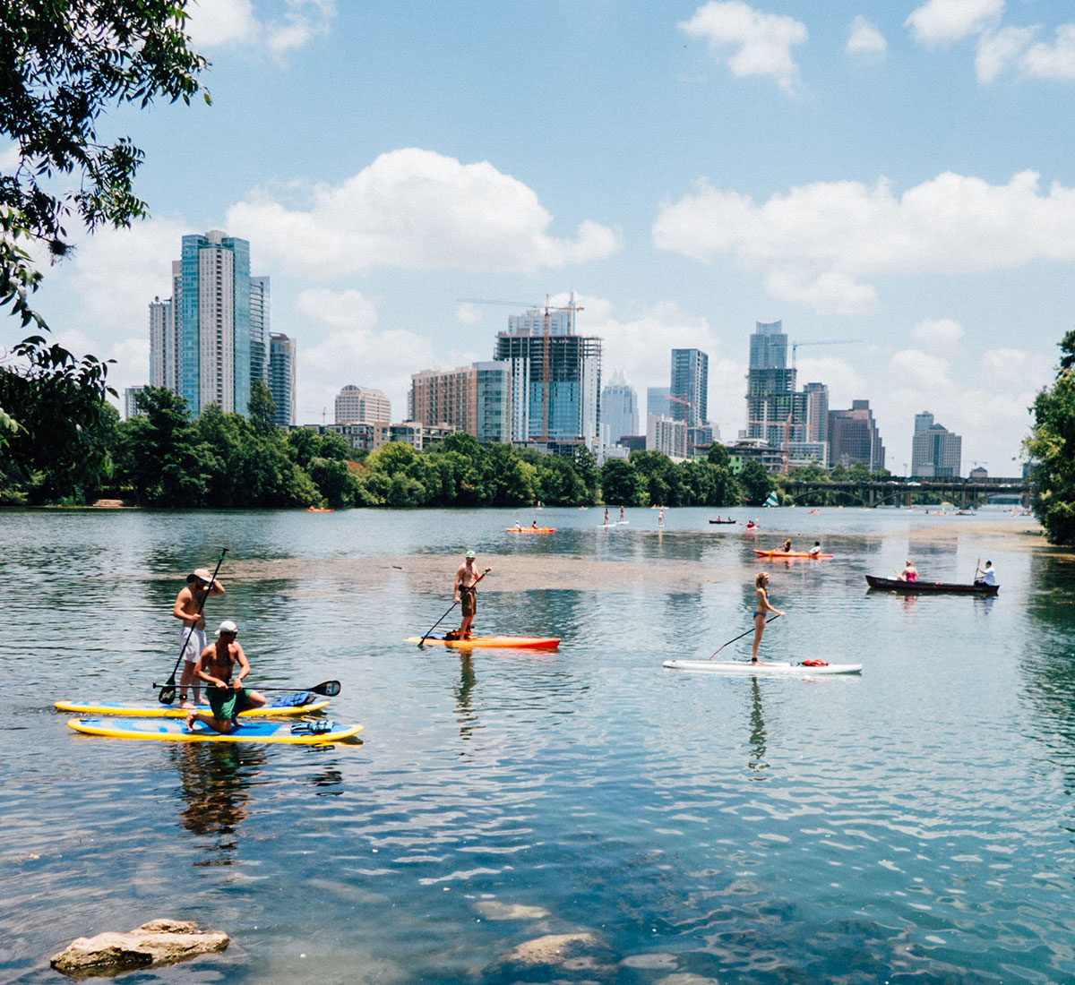 A group of people on standing paddle boards on Lady Bird Lake